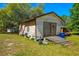 Exterior of shed building with double-door and a sloped wooden ramp in grassy yard at 34200 State Road 62, Parrish, FL 34219