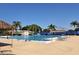 Outdoor community pool with palm trees, lounge chairs, and clear blue water on a sunny day at 3702 Torrey Pines Way, Sarasota, FL 34238