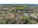 Aerial view of neighborhood with dense tree coverage showing pool, tile roofs and community at 3751 Eagle Hammock Dr, Sarasota, FL 34240
