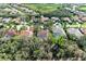A high angle view of neighborhood with tropical foliage featuring pool, and red tiled roofs at 3751 Eagle Hammock Dr, Sarasota, FL 34240
