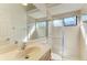 Bathroom featuring a single sink, vanity, and tiled shower with glass doors at 3751 Eagle Hammock Dr, Sarasota, FL 34240
