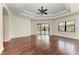 Bedroom with hardwood floors, tray ceiling, ceiling fan, and sliding glass doors at 3751 Eagle Hammock Dr, Sarasota, FL 34240