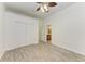 Bedroom featuring wood-look tile flooring, closet, ceiling fan, and bathroom access at 3751 Eagle Hammock Dr, Sarasota, FL 34240