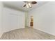 A bright bedroom with wood-look tile flooring, ceiling fan, closet, and ensuite bathroom at 3751 Eagle Hammock Dr, Sarasota, FL 34240