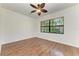 A bright bedroom with wood flooring, ceiling fan and natural light from the window at 3751 Eagle Hammock Dr, Sarasota, FL 34240
