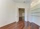 Bright bonus room with hardwood floors, a window with natural light, and built in shelving at 3751 Eagle Hammock Dr, Sarasota, FL 34240