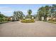 Community entrance featuring brick-paved drive and lush landscaping at 3751 Eagle Hammock Dr, Sarasota, FL 34240