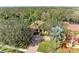 A view of a one-story home featuring tropical landscaping and a brick driveway at 3751 Eagle Hammock Dr, Sarasota, FL 34240