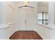 Bright foyer with hardwood floors, white trim, and arched doorway provides a welcoming entrance to the home at 3751 Eagle Hammock Dr, Sarasota, FL 34240