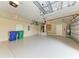 Spacious two car garage featuring epoxy flooring, storage racks, and water heater at 3751 Eagle Hammock Dr, Sarasota, FL 34240