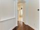 Hallway featuring wood floors that leads to bathroom at 3751 Eagle Hammock Dr, Sarasota, FL 34240