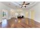 Open-concept floor plan with hardwood floors leads into the dining area featuring updated fixtures and lighting at 3751 Eagle Hammock Dr, Sarasota, FL 34240