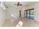 Bright living room with tile flooring, ceiling fan and sliding glass doors to a screened pool at 3751 Eagle Hammock Dr, Sarasota, FL 34240