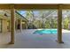 The screened-in pool area features a uniquely shaped pool and views of the lush greenery around the property at 3751 Eagle Hammock Dr, Sarasota, FL 34240