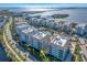 Aerial view of condo buildings on a sunny day, located on a waterway with a view of the ocean in the distance at 383 Aruba Cir # 102, Bradenton, FL 34209