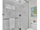 Modern bathroom featuring glass-enclosed shower with white marble tile at 383 Aruba Cir # 102, Bradenton, FL 34209