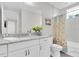 Bright bathroom with a granite countertop vanity, toilet, and shower/tub with a curtain at 383 Aruba Cir # 102, Bradenton, FL 34209