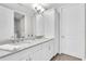 Bathroom boasts double sinks, granite counters, and white cabinets at 383 Aruba Cir # 102, Bradenton, FL 34209