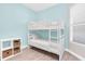 Light and airy bedroom with a bunk bed and a storage shelf near the window at 383 Aruba Cir # 102, Bradenton, FL 34209