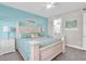 Bedroom with blue accent wall, light colored furniture, and ceiling fan at 383 Aruba Cir # 102, Bradenton, FL 34209