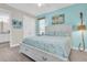 Bedroom featuring a bed, blue accent wall, and gray wood-look flooring at 383 Aruba Cir # 102, Bradenton, FL 34209
