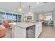 Open-concept kitchen flows into the living and dining areas with granite countertops and stainless steel appliances at 383 Aruba Cir # 102, Bradenton, FL 34209