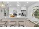 Kitchen features white cabinets, stainless steel appliances, granite countertops, a center island, and an eat-in bar at 383 Aruba Cir # 102, Bradenton, FL 34209
