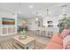 Open-concept living area with dining, kitchen, and living room with coastal decor and plenty of natural light at 383 Aruba Cir # 102, Bradenton, FL 34209