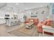 Open concept living area featuring kitchen, living room, and dining area with bright lighting and modern decor at 383 Aruba Cir # 102, Bradenton, FL 34209