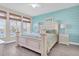 Bright bedroom with waterfront view and light blue accent wall at 383 Aruba Cir # 102, Bradenton, FL 34209