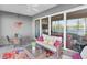 Cozy screened-in porch with seating, a table, and views of the waterway and palm trees at 383 Aruba Cir # 102, Bradenton, FL 34209