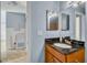 Bathroom with tiled floors, vanity sink and mirror, with hallway view at 4008 Crockers Lake Blvd # 13, Sarasota, FL 34238