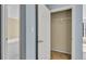 Open closet door showing rack, with view into adjacent room at 4008 Crockers Lake Blvd # 13, Sarasota, FL 34238