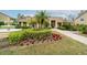 Lush landscaping and water fountain adorn the clubhouse entrance of this community at 4008 Crockers Lake Blvd # 13, Sarasota, FL 34238