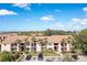 Beige two-story condo building featuring palm trees and a parking lot in a sunny, tropical setting at 4008 Crockers Lake Blvd # 13, Sarasota, FL 34238
