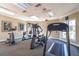 Gym featuring cardio machines, ceiling lights and large windows showing trees outside at 4008 Crockers Lake Blvd # 13, Sarasota, FL 34238