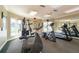 Workout room featuring various exercise machines, large windows with sunlight and mirrored wall at 4008 Crockers Lake Blvd # 13, Sarasota, FL 34238