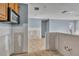 View of a bright, unfinished kitchen showing tile flooring and wooden cabinets at 4008 Crockers Lake Blvd # 13, Sarasota, FL 34238