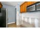 Microwave above oven next to unfinished drywall in partially renovated kitchen with wooden cabinets at 4008 Crockers Lake Blvd # 13, Sarasota, FL 34238