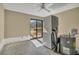The laundry room has a washer, dryer, water heater, sliding glass doors, and ceiling fan at 4008 Crockers Lake Blvd # 13, Sarasota, FL 34238