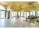 Spacious lobby area featuring a seating area, dining table and a view of the pool at 4008 Crockers Lake Blvd # 13, Sarasota, FL 34238