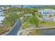 Aerial view of a home near the water featuring a serene seating area and lush tropical landscaping at 4011 11Th Street W Ct, Palmetto, FL 34221