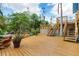 Large wooden deck surrounded by lush landscaping, creating a private and tranquil space at 4114 Roberts Point Cir, Sarasota, FL 34242