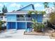 Bright blue, two-story home with garage and balcony in sunny Florida at 4114 Roberts Point Cir, Sarasota, FL 34242