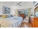 Serene bedroom with a large window, vaulted ceiling, and views of the surrounding greenery at 4114 Roberts Point Cir, Sarasota, FL 34242