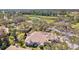 Aerial view of community with ponds and golf course surrounded by lush trees and greenery at 4452 Oakley Greene # 49, Sarasota, FL 34235