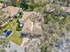 Aerial view of home with manicured lawn, patio area and driveway; lush trees at 4452 Oakley Greene # 49, Sarasota, FL 34235