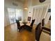 Light-filled dining area with wicker chairs, glass table, and sliding doors to the outdoor patio at 4515 50Th W Dr, Bradenton, FL 34210