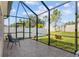 Screened-in lanai with brick flooring offers backyard views in a private outdoor space at 4574 Cedar Brush Ter, Sarasota, FL 34243