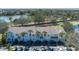 Aerial view highlights the townhomes, parking, and community amenities around a pond at 4658 Sabal Key Dr, Bradenton, FL 34203